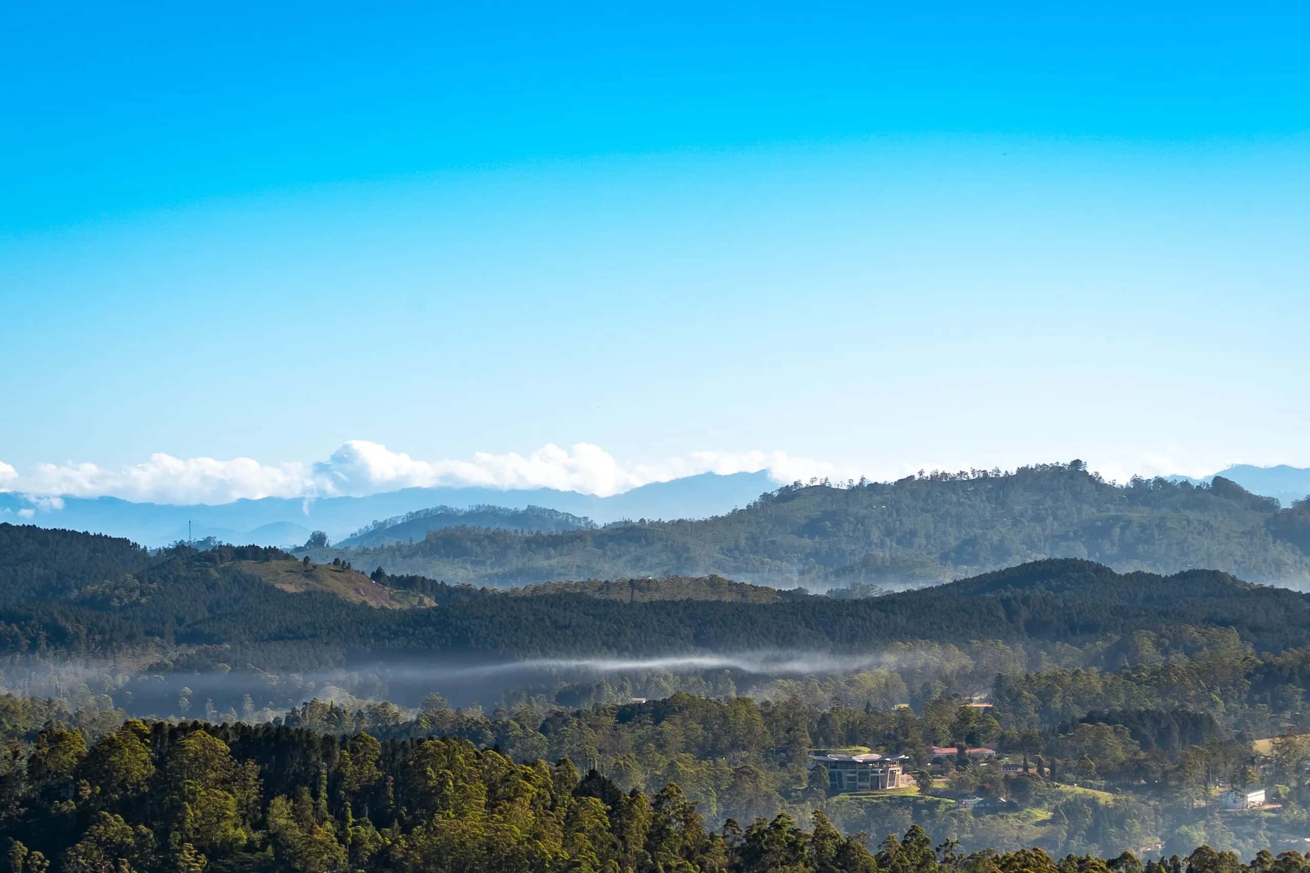 Layered highland ridges under morning mist